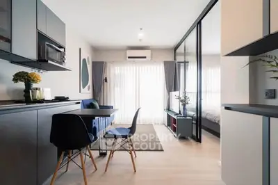 Modern open-plan living room with sleek kitchen and stylish decor