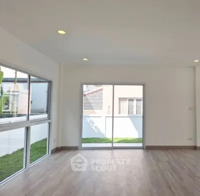 Spacious modern living room with large windows and garden view