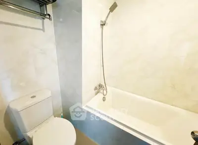 Modern bathroom with sleek white bathtub and elegant fixtures