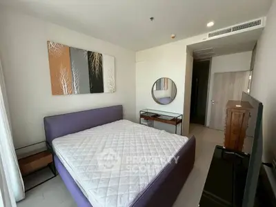 Modern bedroom with stylish decor and large bed in a contemporary apartment.