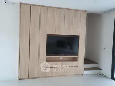 Modern living room with built-in wooden TV cabinet and sleek design