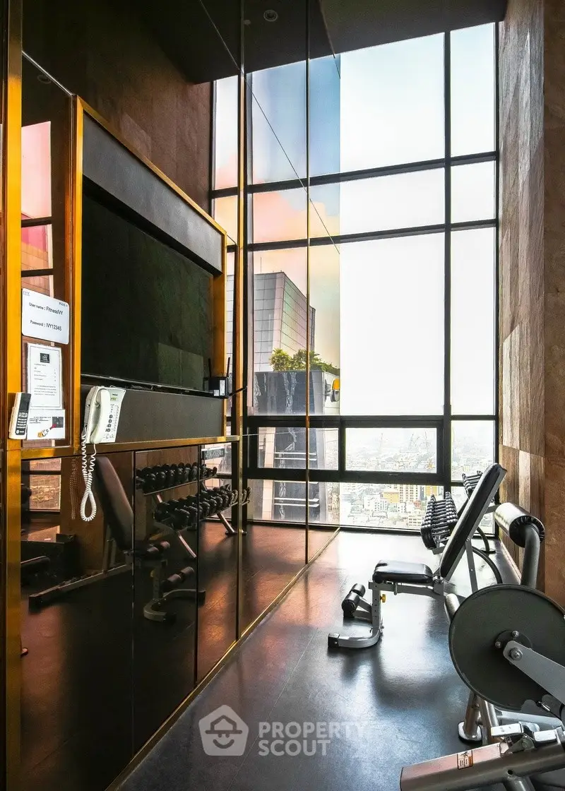 Luxurious high-rise gym with panoramic city views and modern fitness equipment.