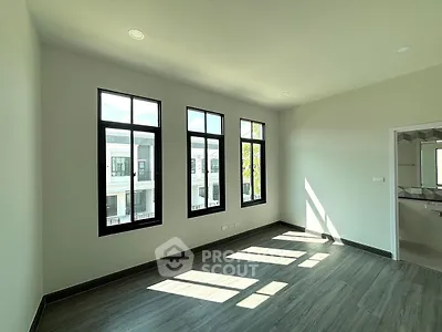 Bright and spacious room with large windows and modern flooring, perfect for a stylish home.