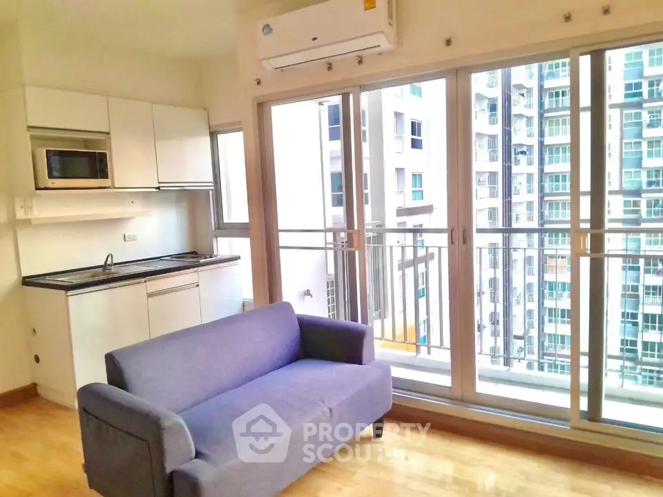 Modern living room with balcony view in high-rise apartment