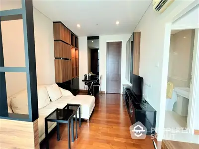 Spacious living room with polished hardwood floors, modern furniture, and ample natural light, perfect for urban living.