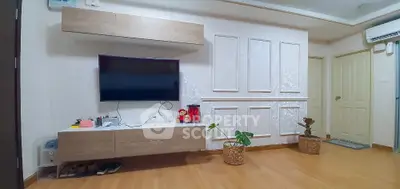 Modern living room with wall-mounted TV and stylish decor