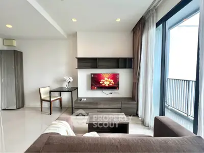Modern living room with sleek furniture and balcony view