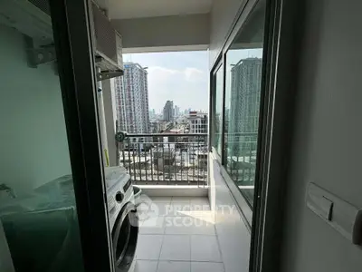 Modern apartment balcony with laundry area and city view, perfect for urban living.