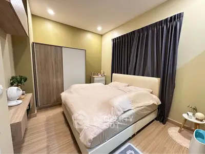 Cozy bedroom with modern decor and ample natural light