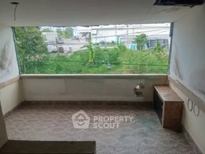 Spacious balcony with garden view in a serene residential area