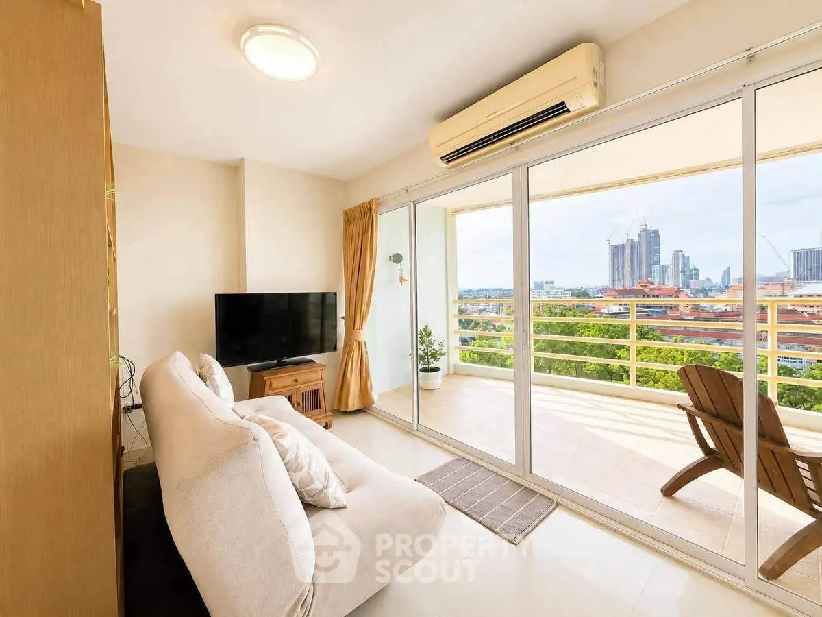 Spacious living room with large balcony and stunning city view, perfect for relaxation and entertainment.
