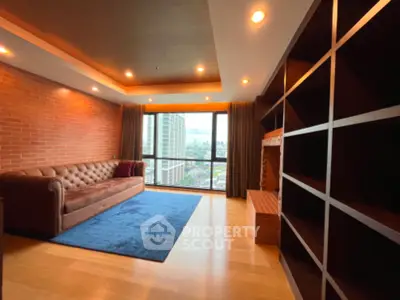 Spacious living room with city view and modern brick accent wall