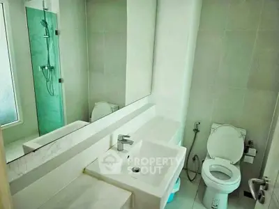 Modern bathroom with sleek fixtures and glass shower enclosure