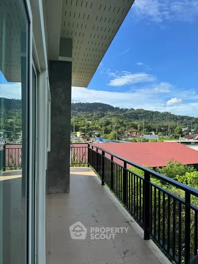 Spacious balcony with scenic mountain view, perfect for relaxation and outdoor enjoyment.