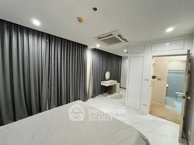 Modern bedroom with ensuite bathroom and elegant gray curtains