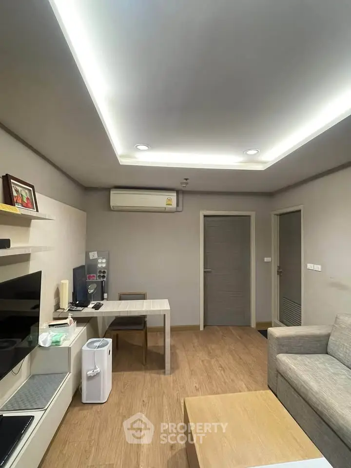 Modern living room with sleek design, featuring a cozy sofa, stylish table, and efficient air conditioning.