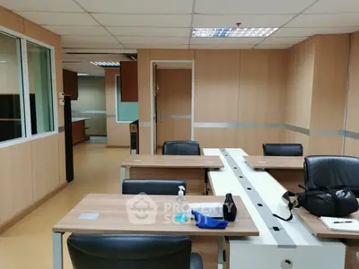 Modern office space with sleek wooden desks and leather chairs, ideal for productivity and collaboration.