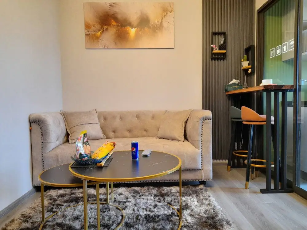 Modern living room with plush sofa, stylish decor, and cozy ambiance.