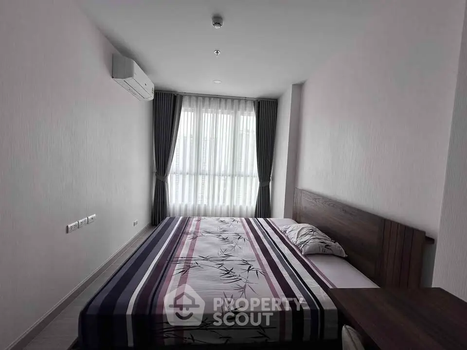 Modern bedroom with stylish decor and natural light in a contemporary apartment.