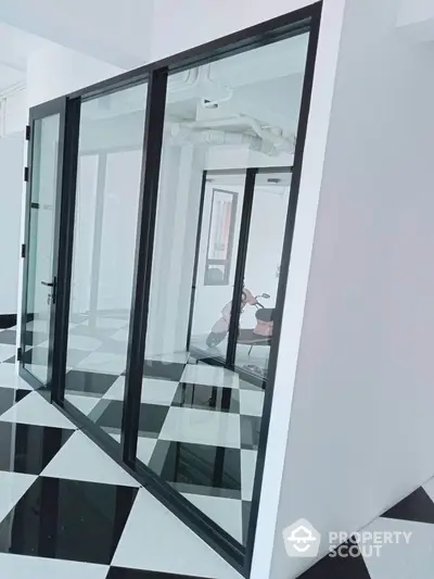 Modern interior with glass walls and checkered floor tiles