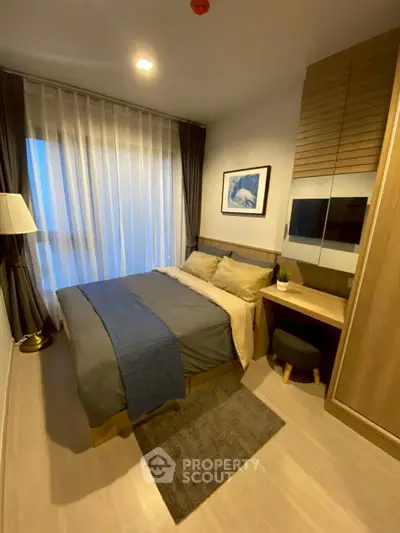 Cozy modern bedroom with stylish decor and ample natural light