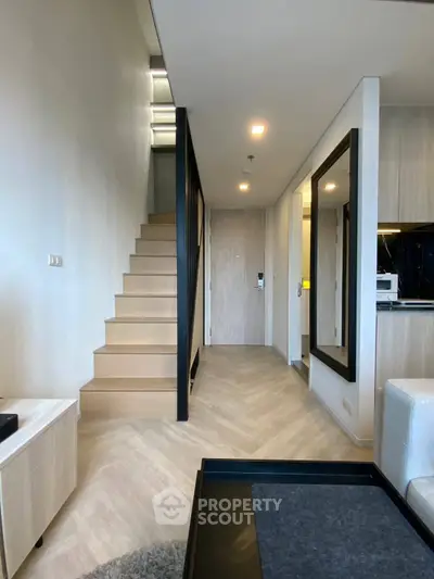 Modern duplex apartment with sleek staircase and open kitchen layout