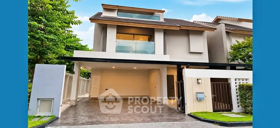 Modern two-story house with spacious driveway and sleek architectural design.
