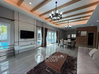 Luxurious living room with modern decor and pool view, featuring elegant lighting and spacious design.