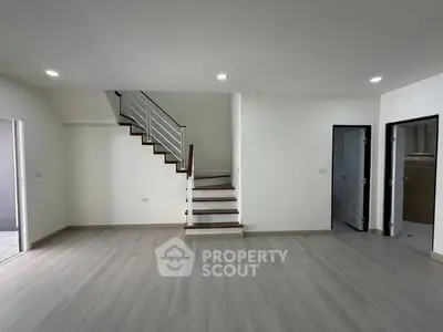 Spacious modern living room with sleek staircase and minimalist design