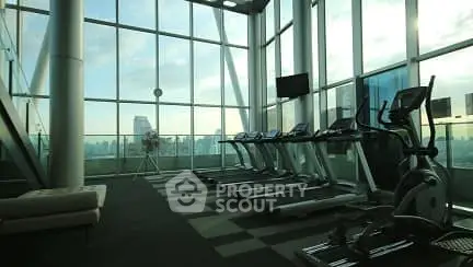 Modern gym with panoramic city views and state-of-the-art equipment.