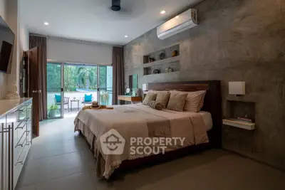 Luxurious bedroom with modern decor and balcony access in a stylish home.