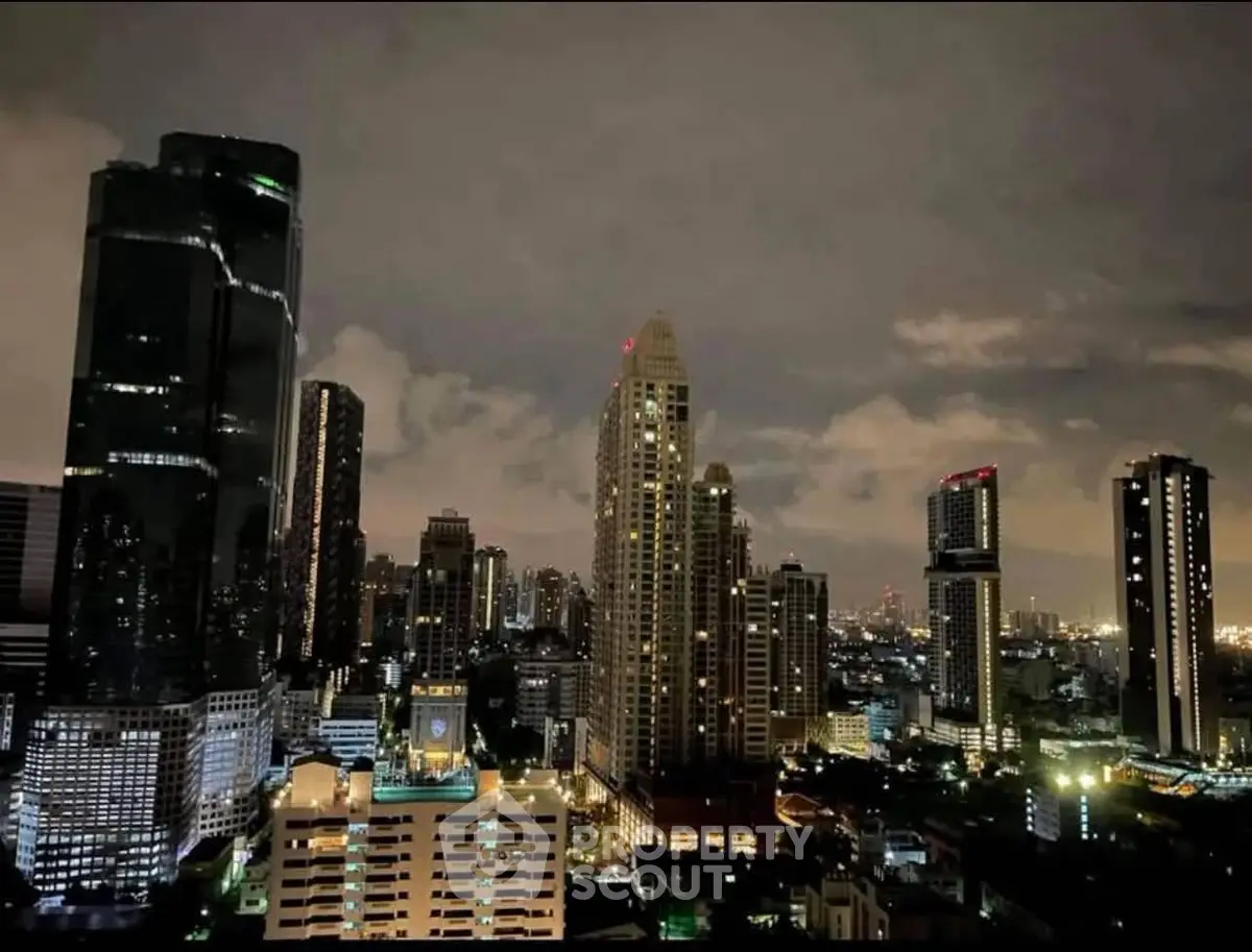 Stunning city skyline view with illuminated skyscrapers at night, showcasing urban living at its finest.