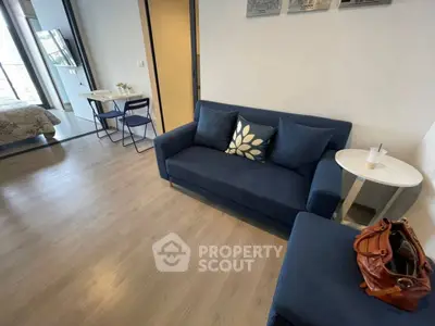 Modern living room with blue sofa and open layout in stylish apartment