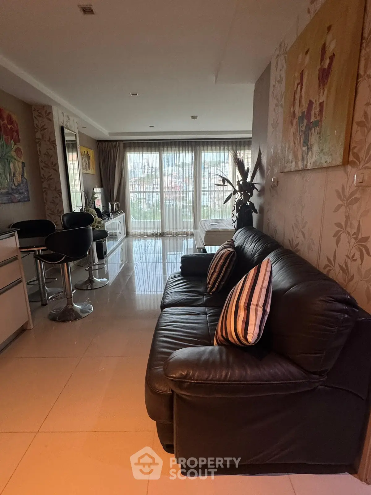 Spacious living room with modern decor and large windows for natural light