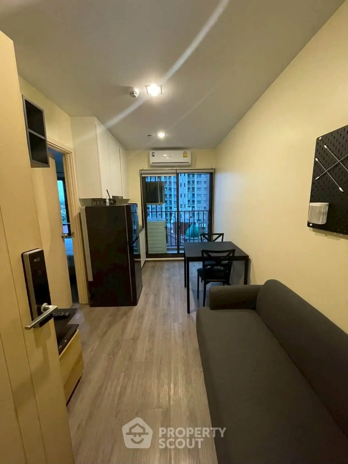 Modern apartment interior with sleek furniture and balcony view, perfect for urban living.