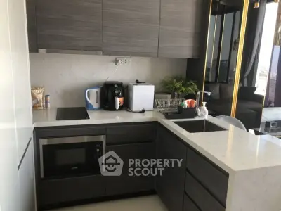 Modern kitchen with sleek cabinetry and built-in appliances in a stylish apartment.