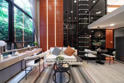 Modern living room with high ceilings, large windows, and stylish decor, featuring a mezzanine and contemporary furniture.