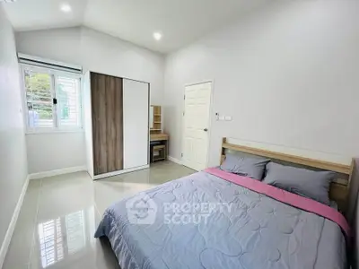 Spacious bedroom with modern decor and ample natural light