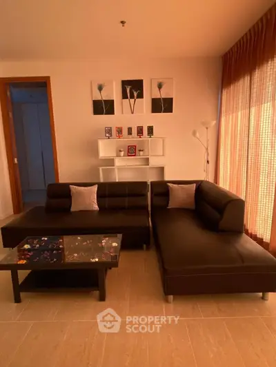 Modern living room with stylish black sofas and elegant decor