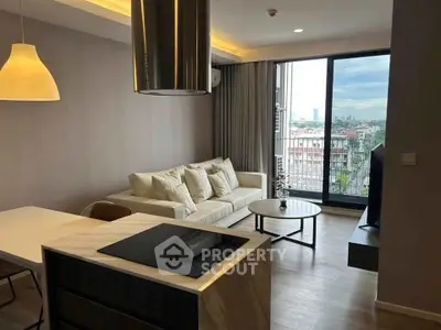 Modern living room with city view, featuring cozy sofa and stylish lighting.