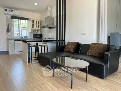 Modern open-layout living room with sleek kitchen and stylish furniture