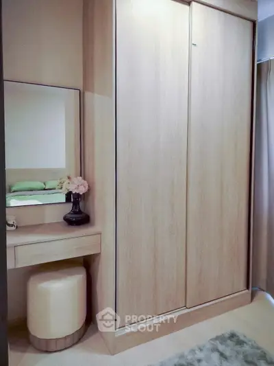 Modern bedroom with sleek wardrobe and stylish vanity area