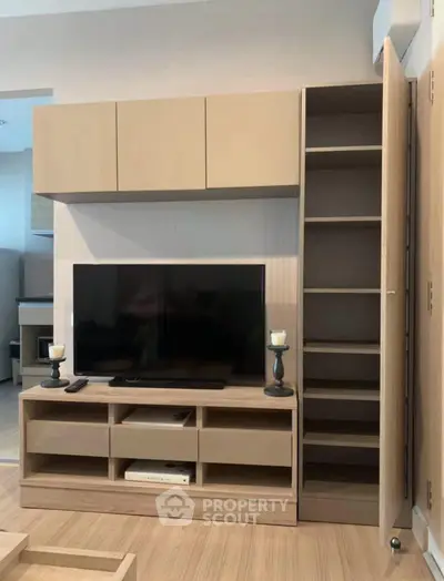 Modern living room with sleek TV unit and ample storage space