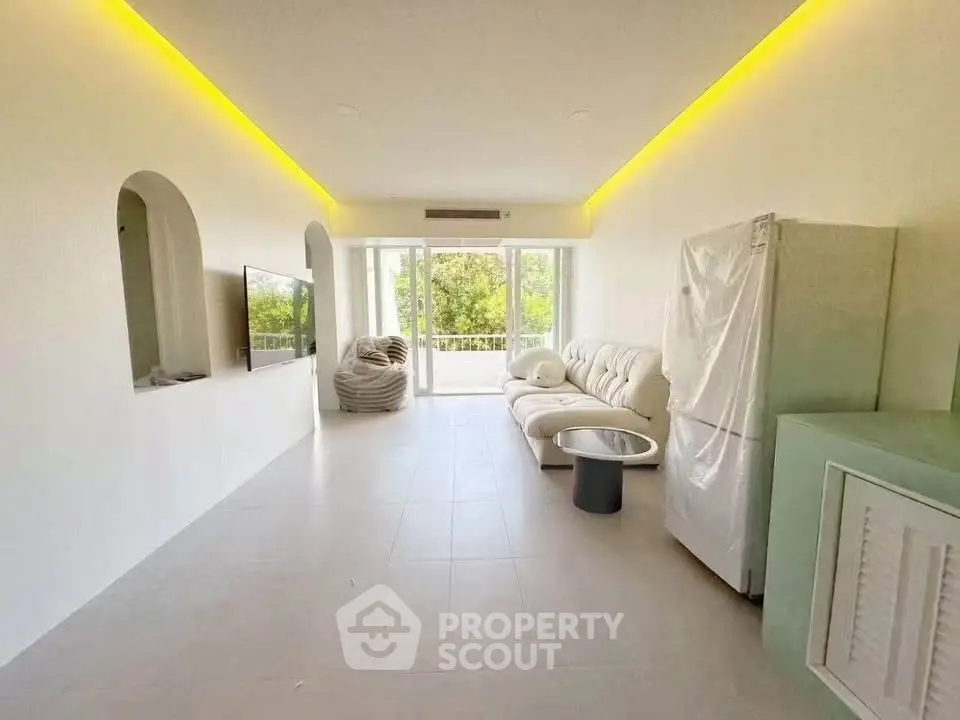 Spacious modern living room with large windows and stylish furniture