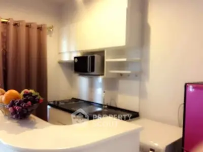 Charming kitchen with modern appliances and sleek white cabinetry