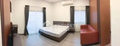 Spacious bedroom with modern furnishings and natural light