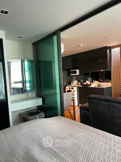 Modern open-layout apartment with sleek kitchen and cozy living area, perfect for urban living.