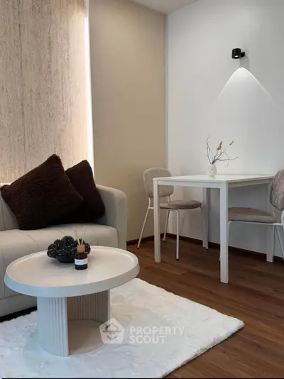 Modern living room with cozy seating and elegant decor in a stylish apartment.