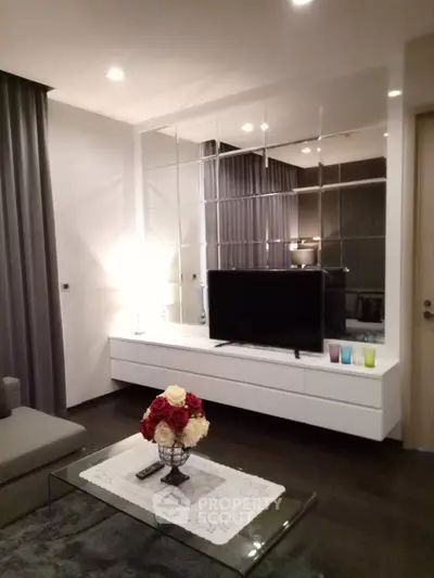 Modern living room with stylish decor and mirrored wall feature