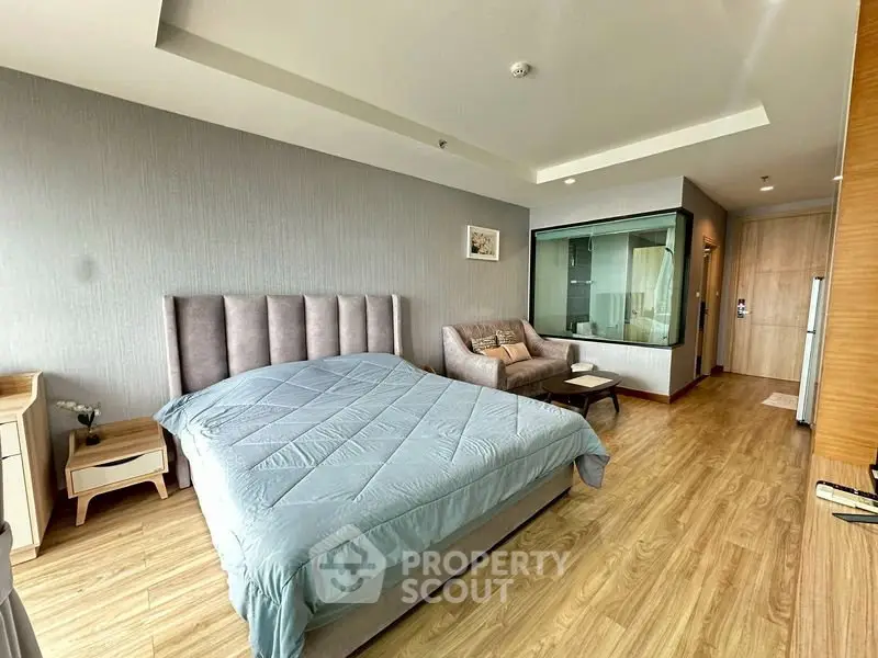 Modern bedroom with stylish decor and cozy seating area